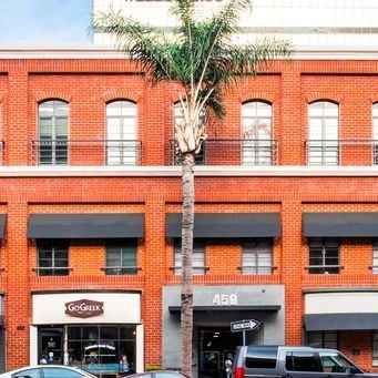 Aviara center building exterior in Beverly Hills with palm tree in front.