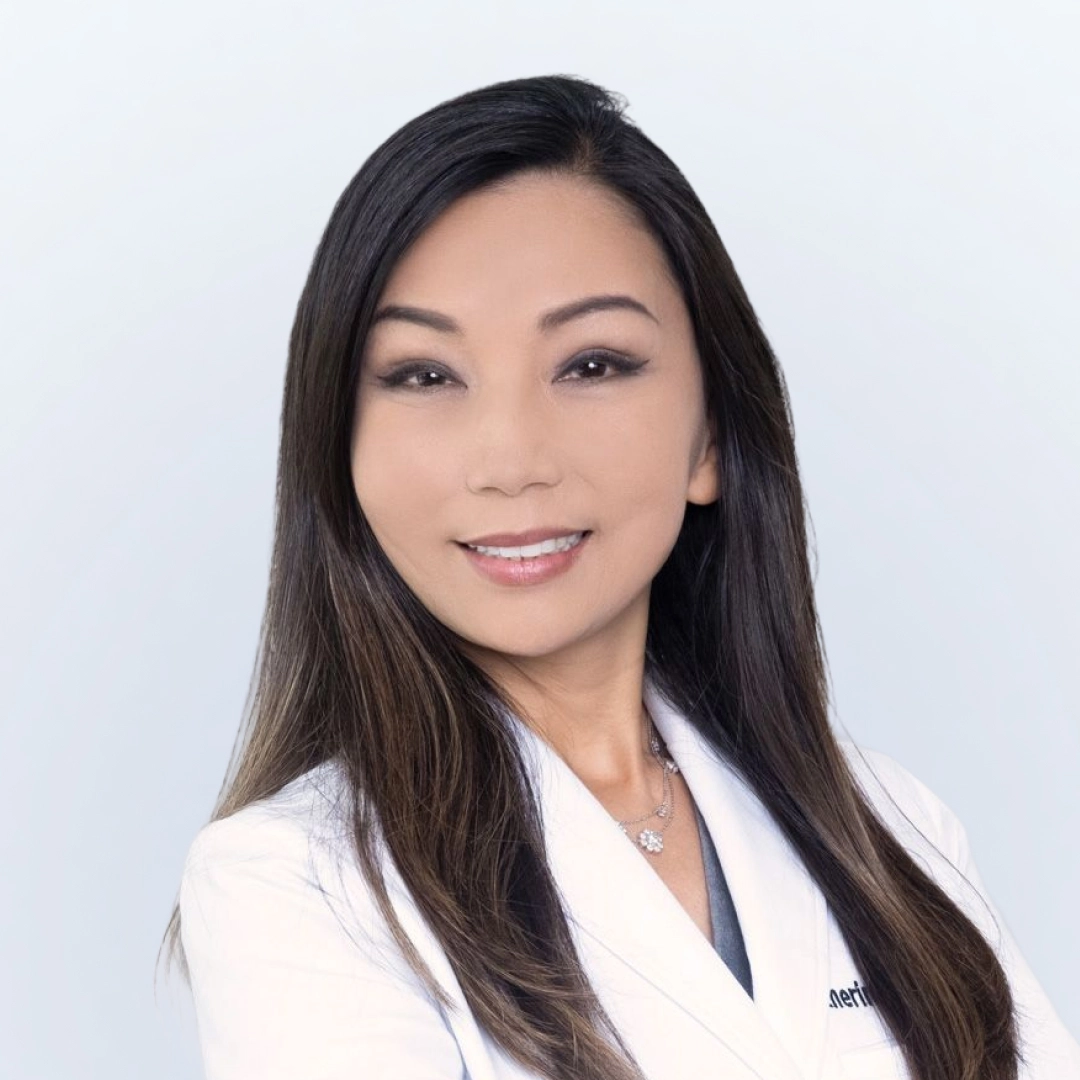 Professional photograph of Dr. Katherine Ahn-Wallace in studio and lab coat